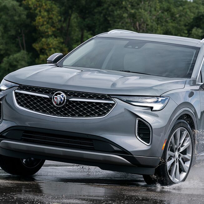 2023 Buick Envision Avenir driving on wet terrain.