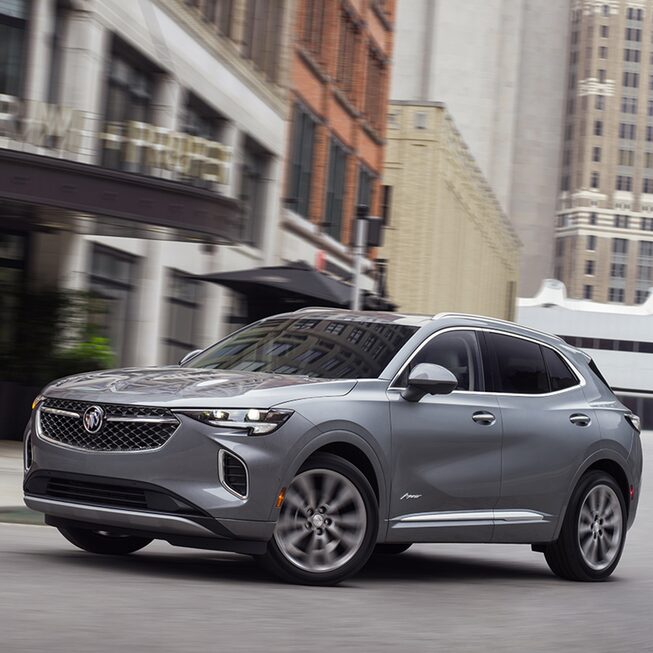 Front side profile view of the 2023 Buick Envision Avenir parked on the road.