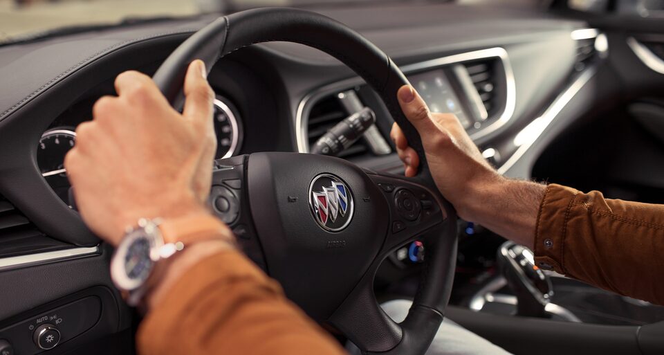 Hands On The Steering Wheel Of The Buick Enclave Mid-Size SUV.