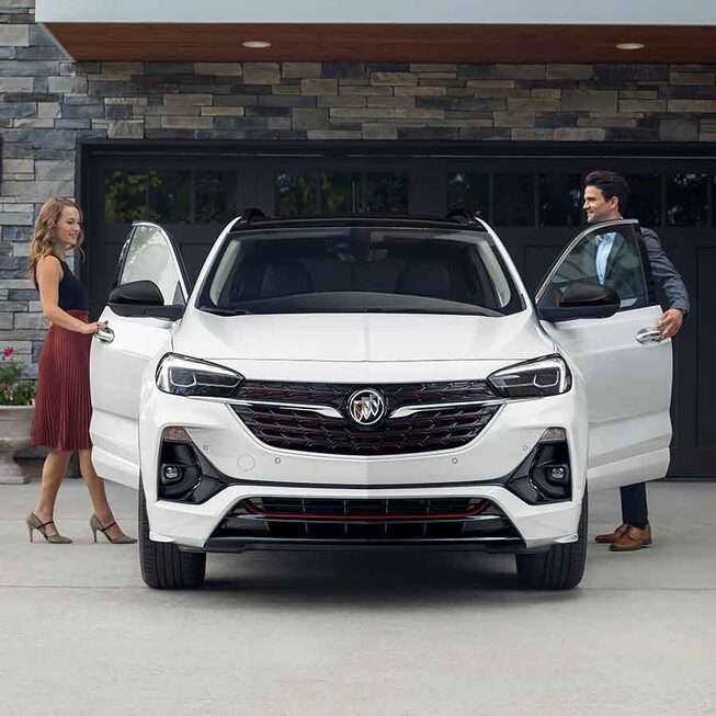 Two persons getting in the 2022 Buick Encore GX ST.