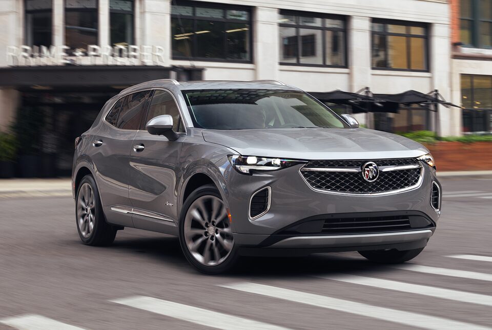 Front profile view of the 2022 Buick Envision parked outside a home.