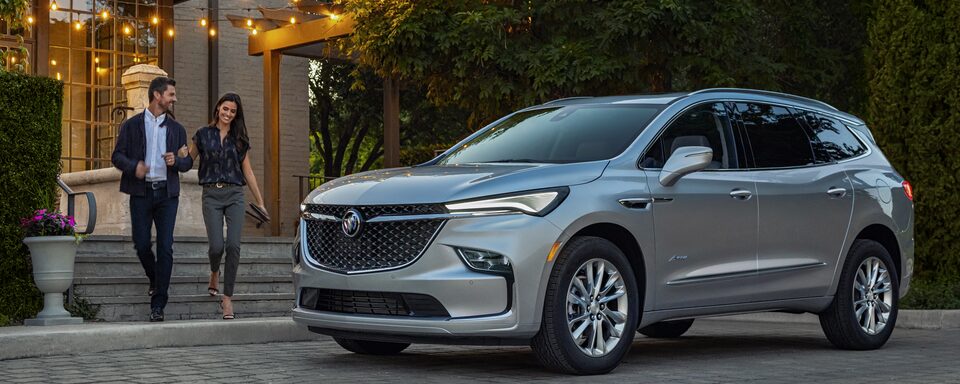 A couple about to enter the 2022 Enclave Avenir.