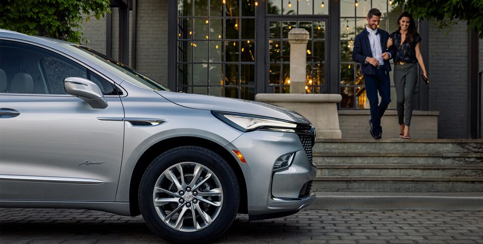 A couple about to enter the 2022 Enclave Avenir.