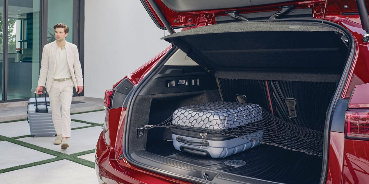 Close-up View of the Open Trunk on a 2025 Buick Envision ST Sporty Compact SUV as a person passes by.