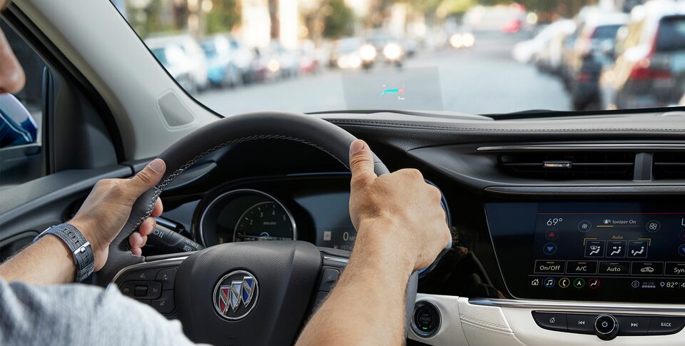 Interior dashboard of the 2022 Buick Encore GX featuring the steering wheel and infotainment system.