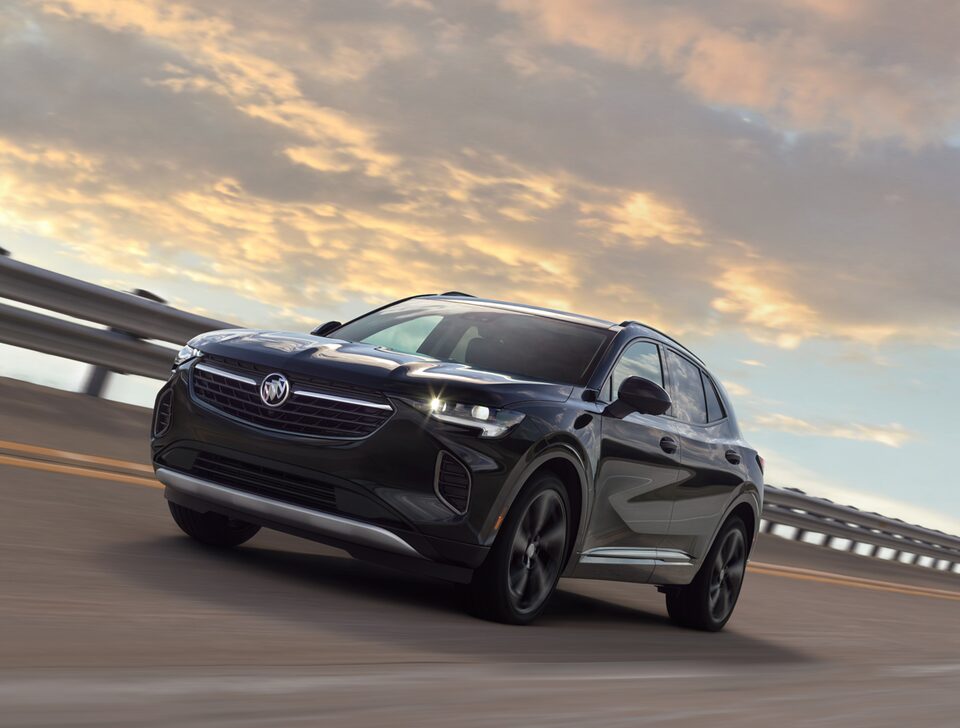 Front side profile view of the 2022 Buick Envision driving on the road.