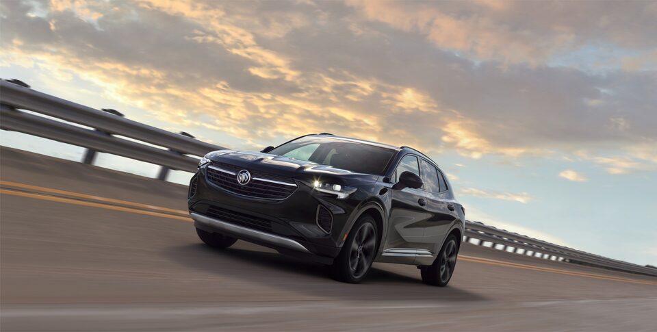 2023 Buick Envision ST driving on a road.