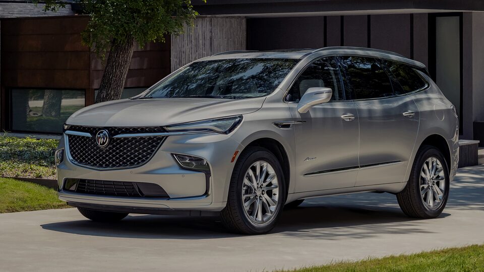 2023 Enclave Avenir parked outside a home.
