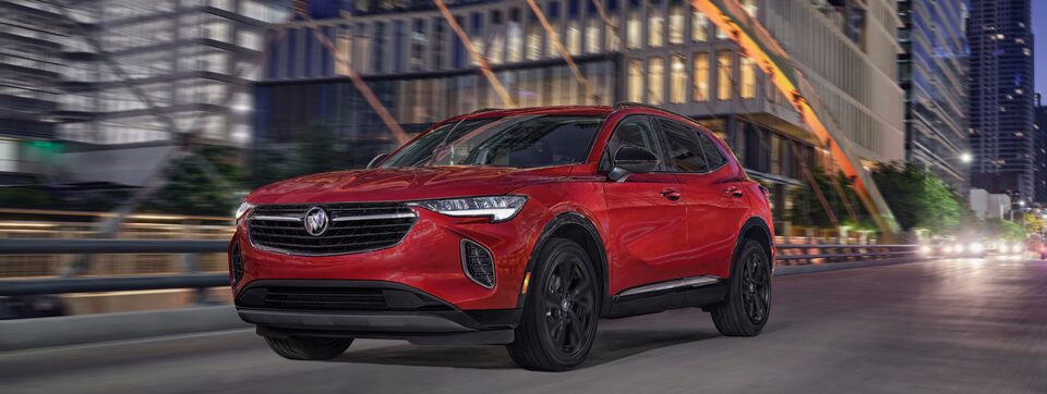 2023 Envision Sport Touring parked outside a home.