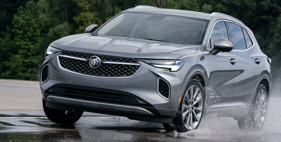 2023 Buick Envision driving on the a puddle of water.