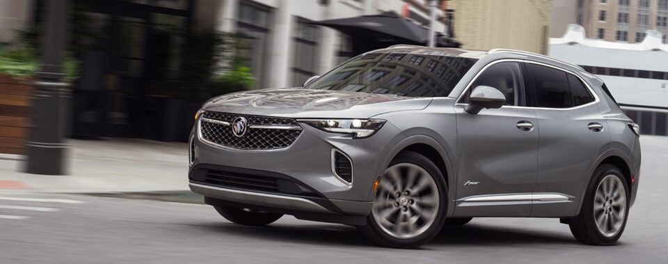 2023 Buick Envision compact SUV driving on the road.