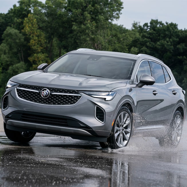 2023 Buick Envision driving on the a puddle of water.