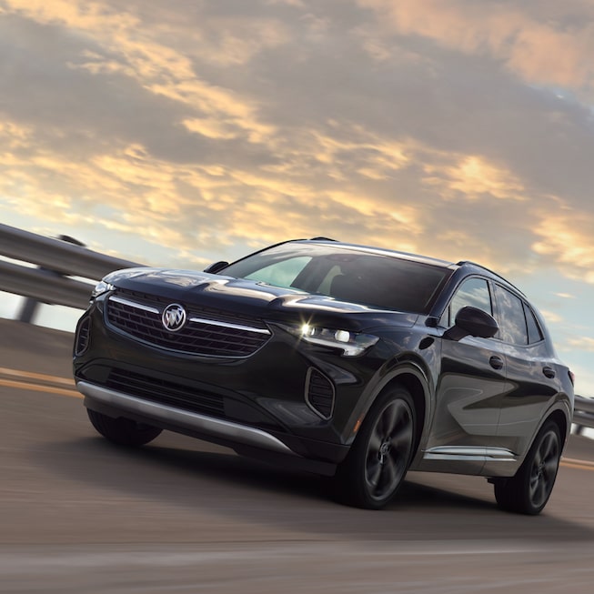 2023 Envision compact SUV driving on the road.