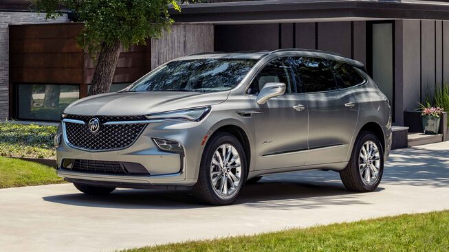 2024 Buick Enclave Avenir parked in front of a family home.