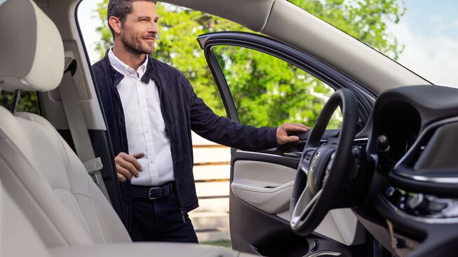  Opening the front door to the 2024 Buick Enclave.