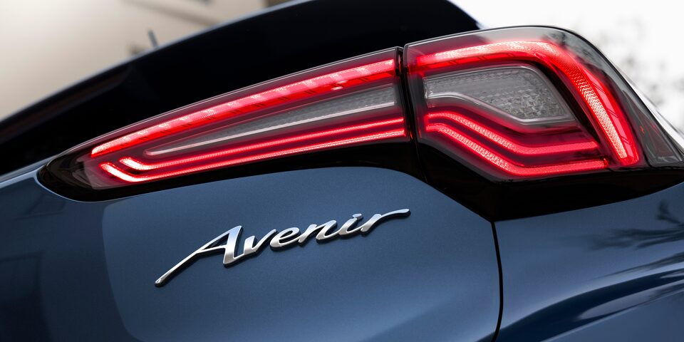 Close-up of 2024 Buick Encore GX Avenir logo and tail light.