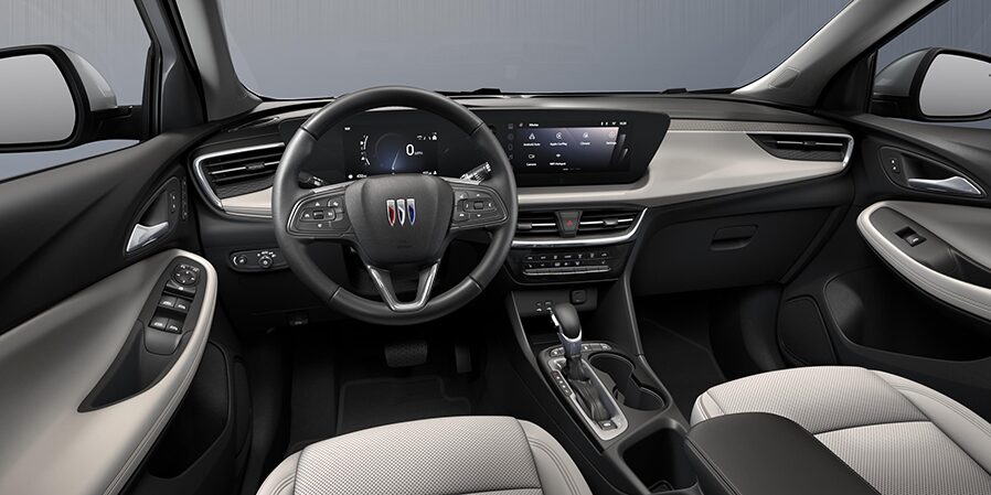 2024 Buick Encore GX Avenir front interior in Whisper Beige with Ebony Accents.