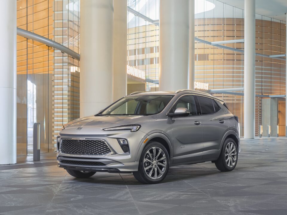 Silver-colored 2024 Encore GX parked inside a building.