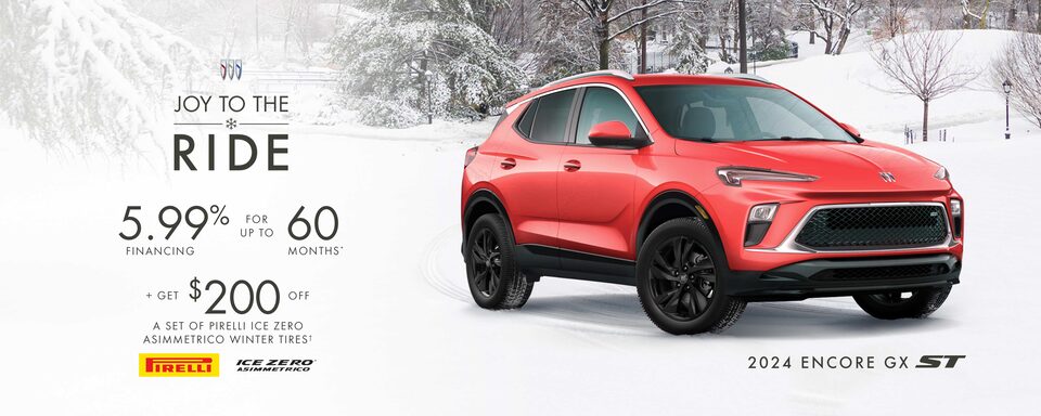 Side view of the 2024 Encore GX parked outside a white building.