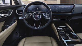2024 Buick Envision front interior featuring the steering wheel and infotainment system.