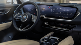 2024 Envision front interior featuring the steering wheel and infotainment system.