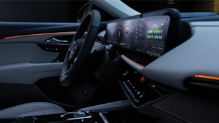 2024 Buick Envision front interior featuring the infotainment system and steering wheel.