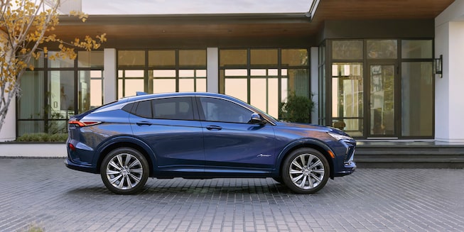 Right side view of the 2024 Buick Envista Avenir parked outside a home.