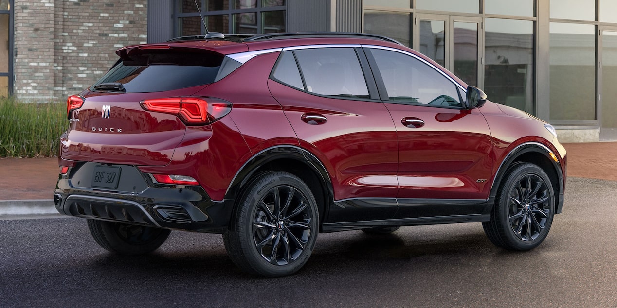 Rear-side view of the 2025 Buick Encore GX ST parked outside a building.