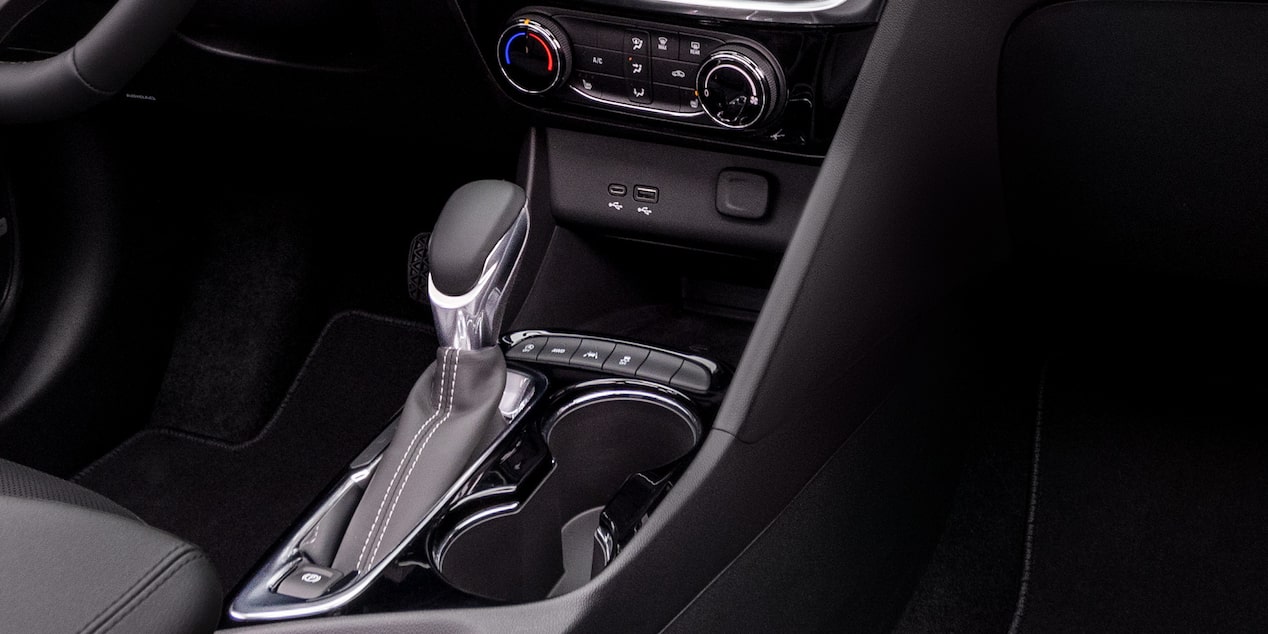 Interior view of the 2025 Buick Encore GX ST as a person opens the vehicle door.