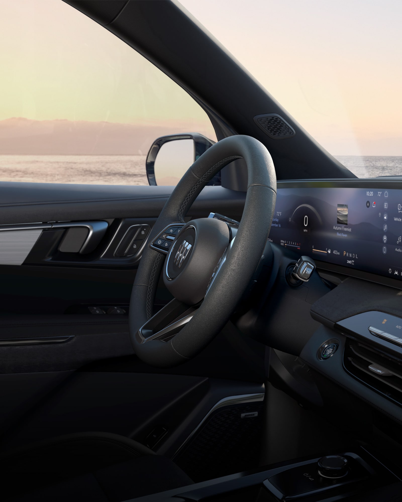 Side view of the steering wheel and infotainment system inside the 2026 Enclave Preferred.