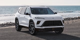 Front-side view of a 2026 Buick Enclave parked by the beach.