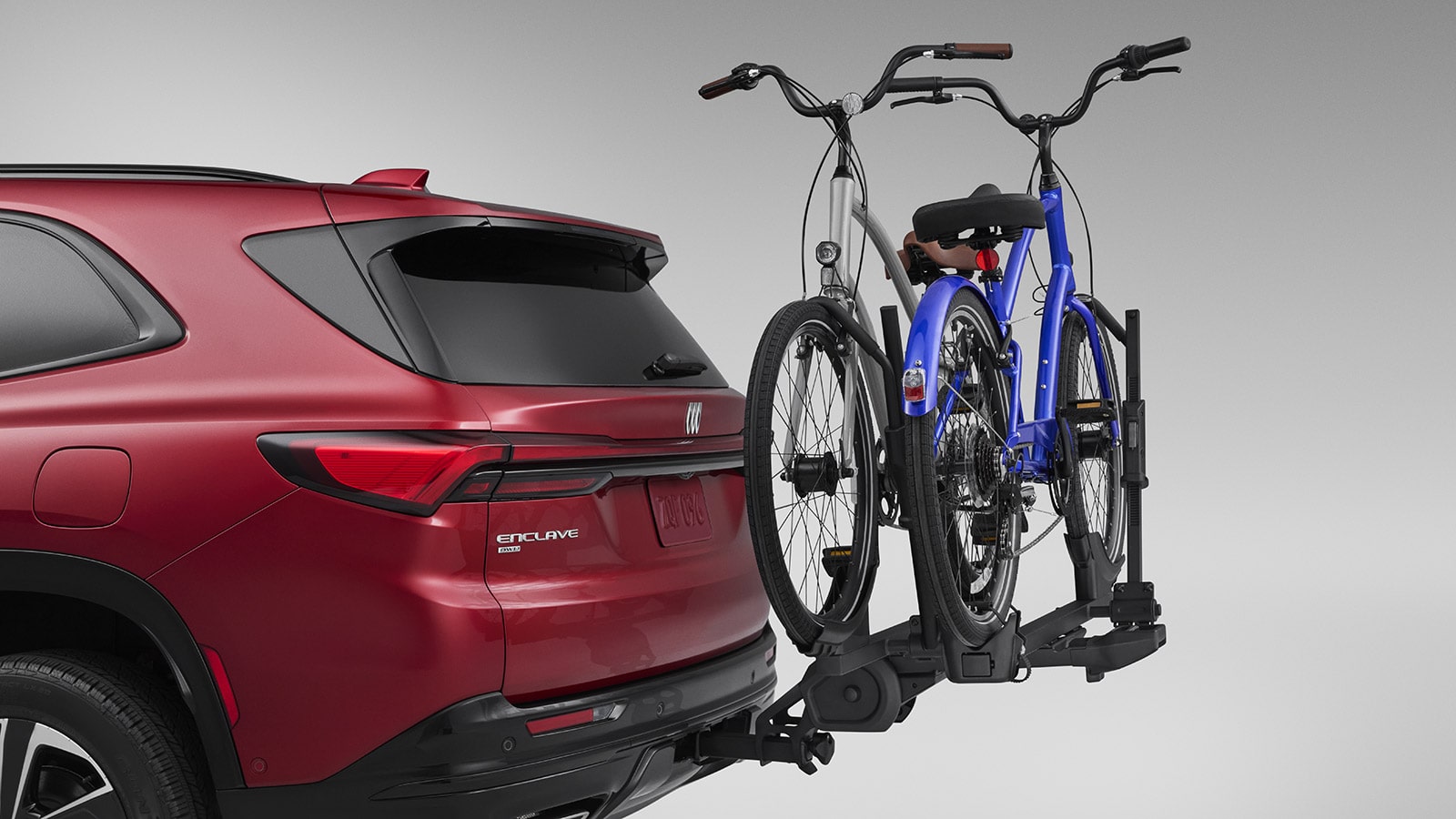 Side view of the 2026 Buick Enclave ST with a Bicycle attached in its rear.