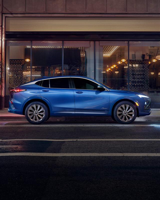 Side view of the 2026 Buick Envista Avenir parked by the sidewalk.