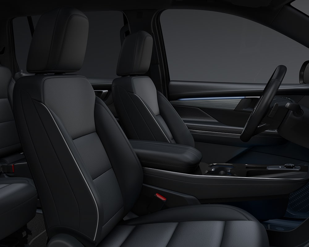 Une photo intérieure d’un VUS préféré Buick Enclave 2027 avec des sièges avant noirs et gris.