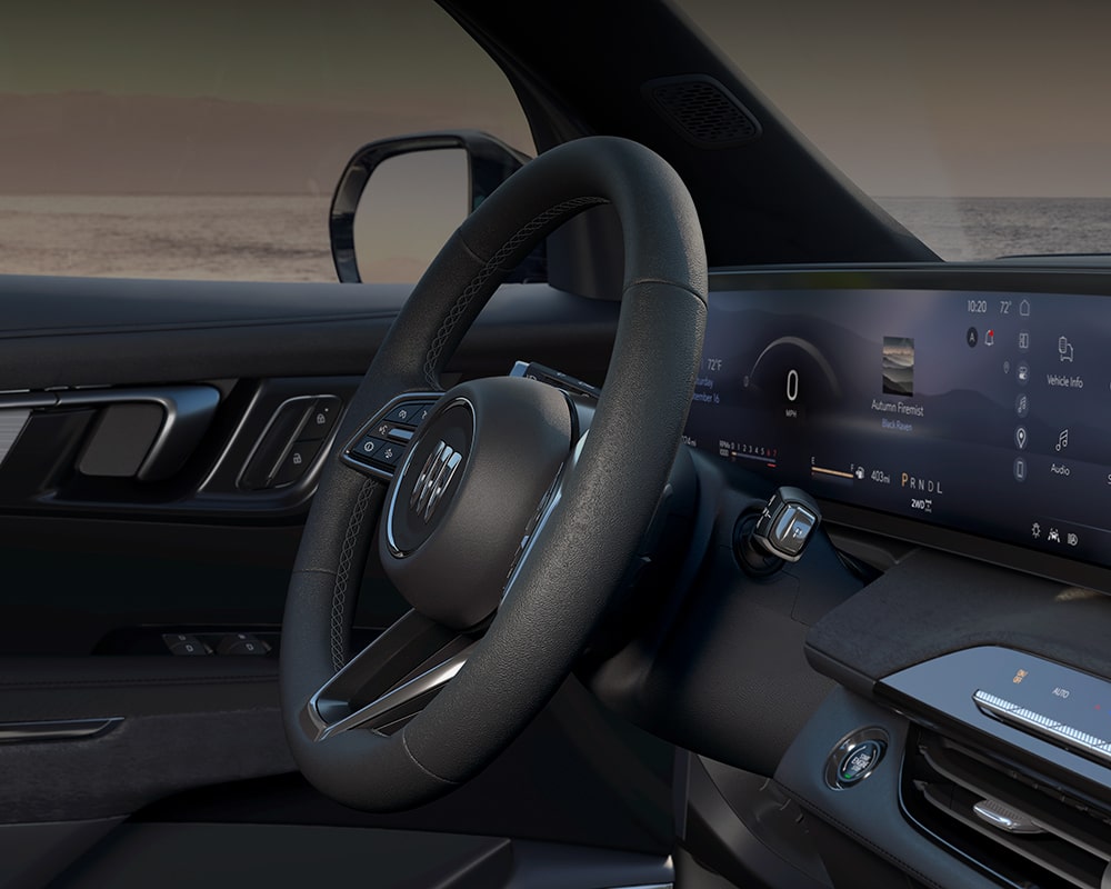Une photo intérieure d’une Buick Enclave 2027 préférée avec le volant et un large écran numérique.