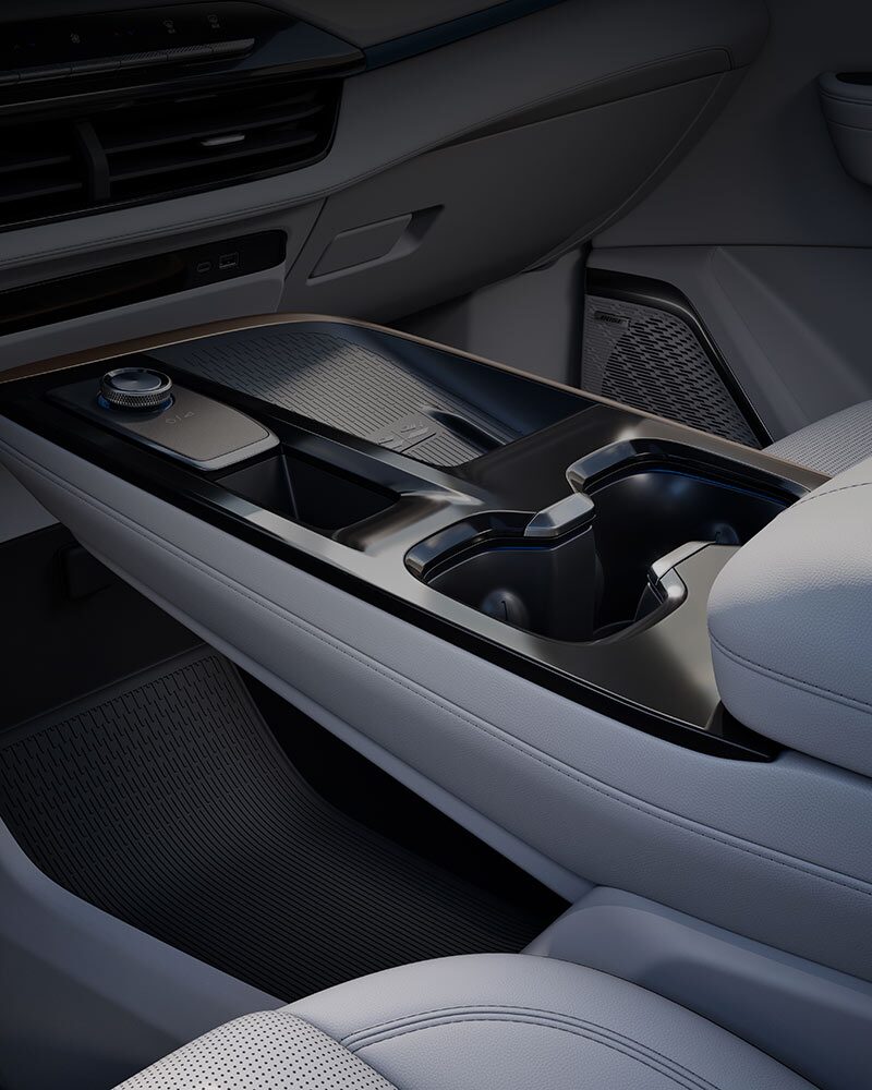 Un gros plan sur la console centrale et le tableau de bord d’une Buick Enclave 2027 avec un cadran de sélecteur de vitesses et des porte-gobelets.
