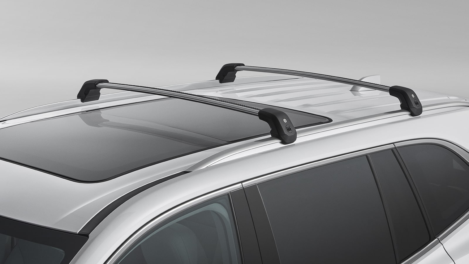 A Silver 2027 Buick Enclave Avenir SUV with Black Roof Racks Installed and a Sunroof.