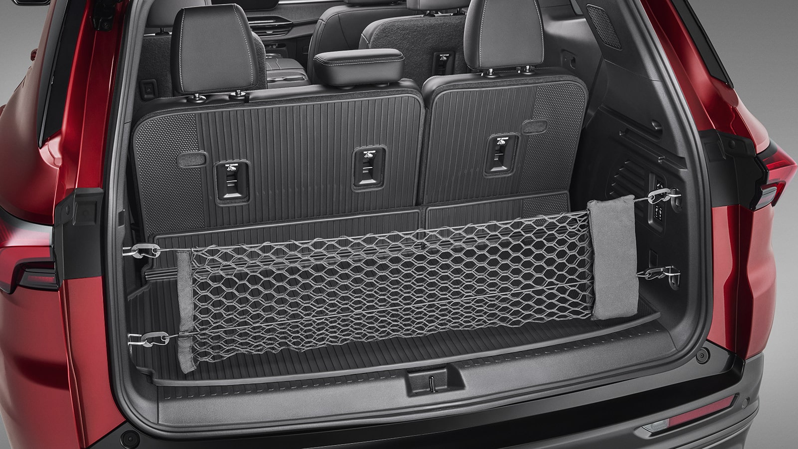 An Open Trunk of a Red 2027 Buick Enclave Avenir SUV Showing a Cargo Net.