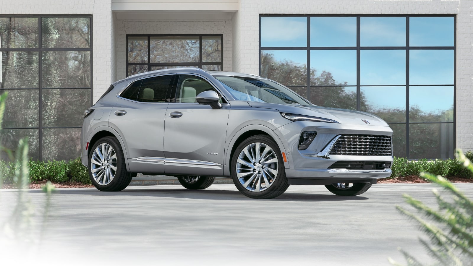 Front Three-Quarters View of a Blue 2026 Buick Envision Avenir Luxury SUV with a Gloss Black Grille.