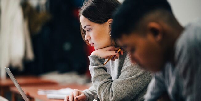 Two students studying for a test  eligible for GM's Student Bonus Program.