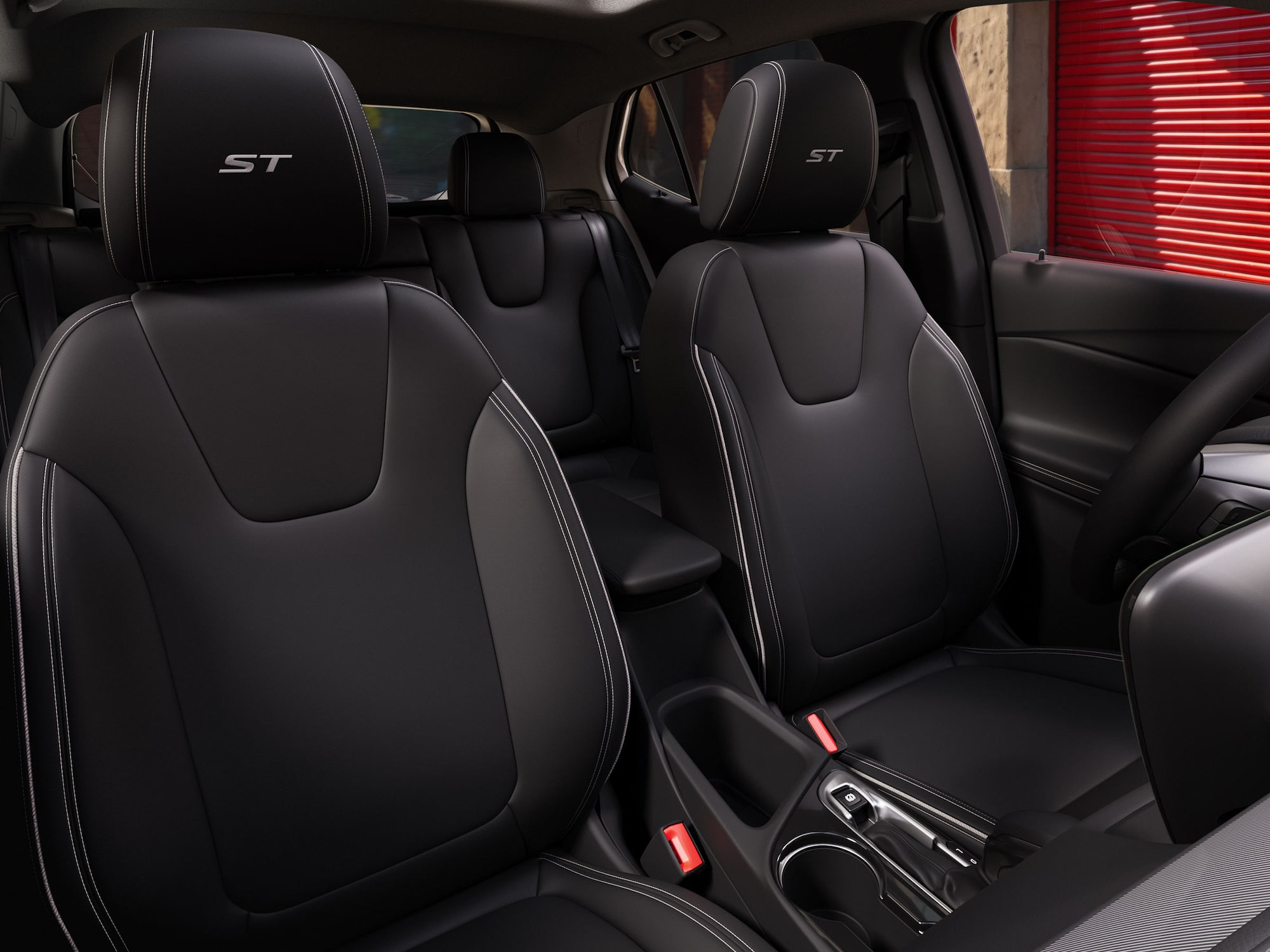 Three-quarters View of the 2026 Buick Envista Driving Out of the City Under a Street Light