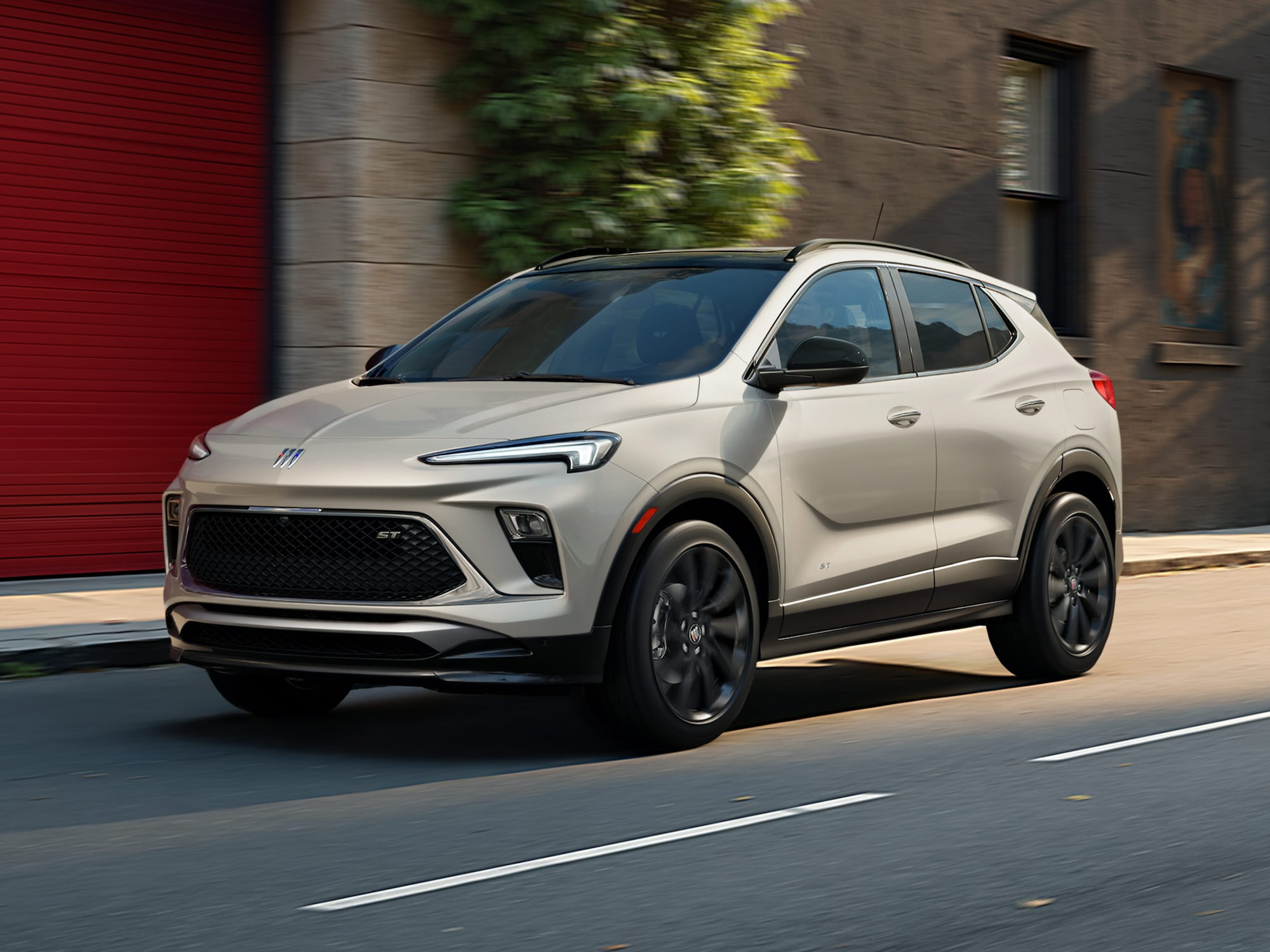 Three-quarters View of the 2026 Buick Envista Driving Out of the City Under a Street Light