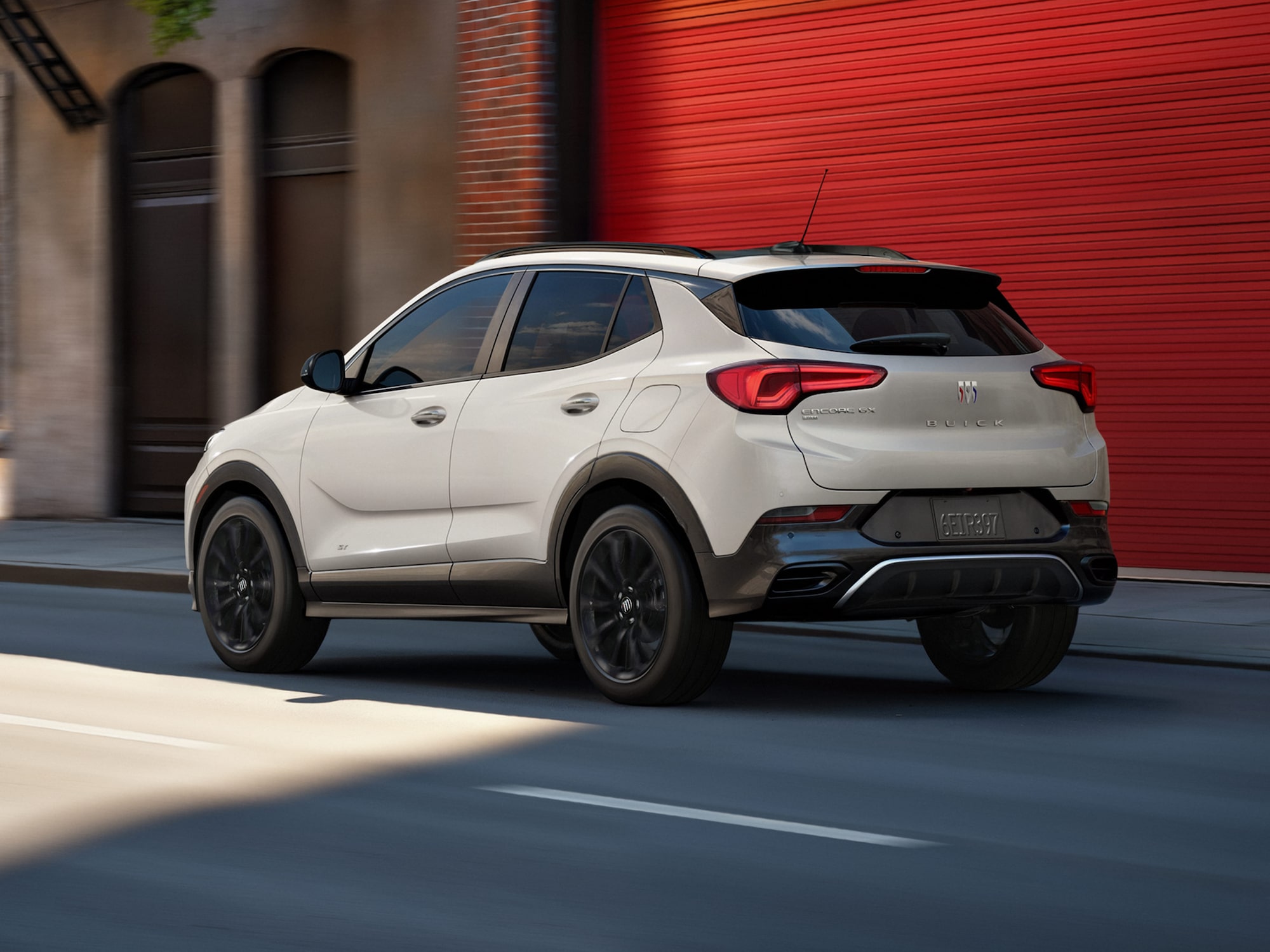 Three-quarters View of the 2026 Buick Envista Driving Out of the City Under a Street Light