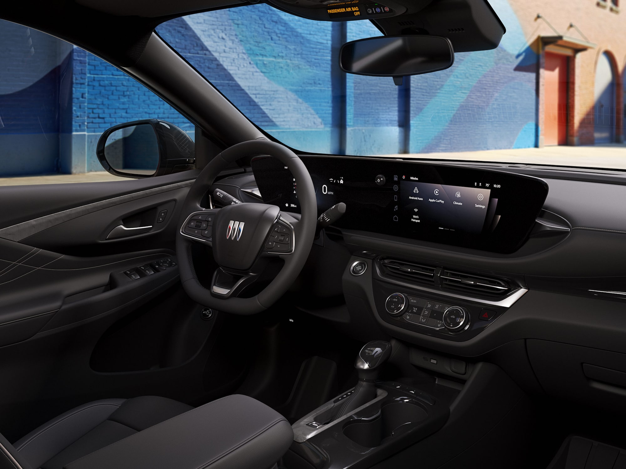 Three-quarters View of the 2026 Buick Envista Driving Out of the City Under a Street Light