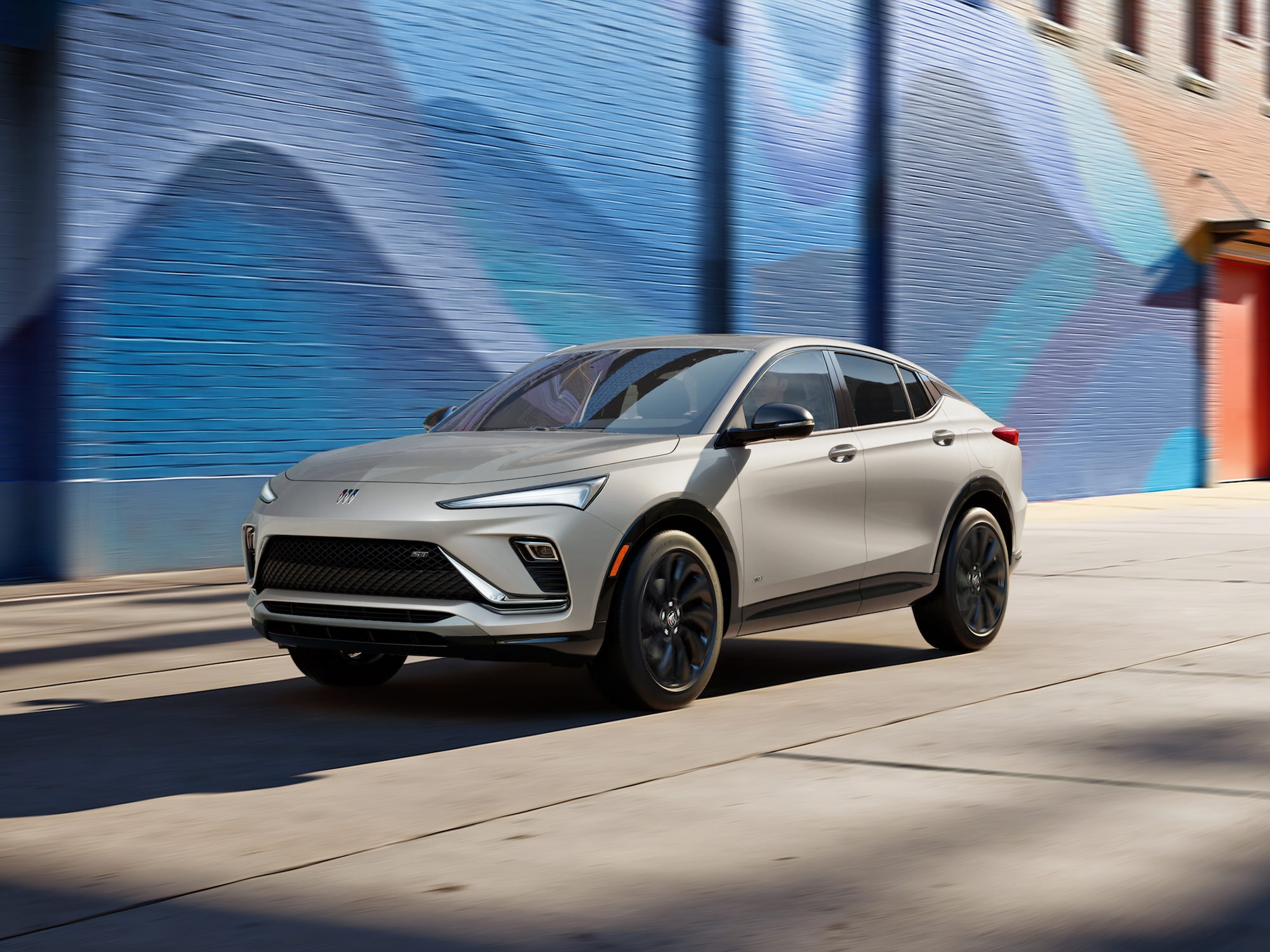 Three-quarters View of the 2026 Buick Envista Driving Out of the City Under a Street Light