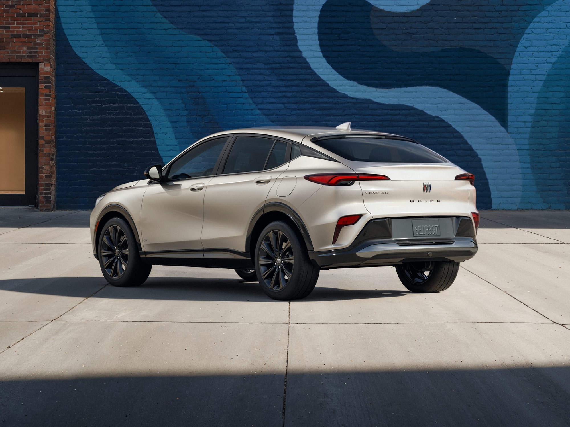 Three-quarters View of the 2026 Buick Envista Driving Out of the City Under a Street Light