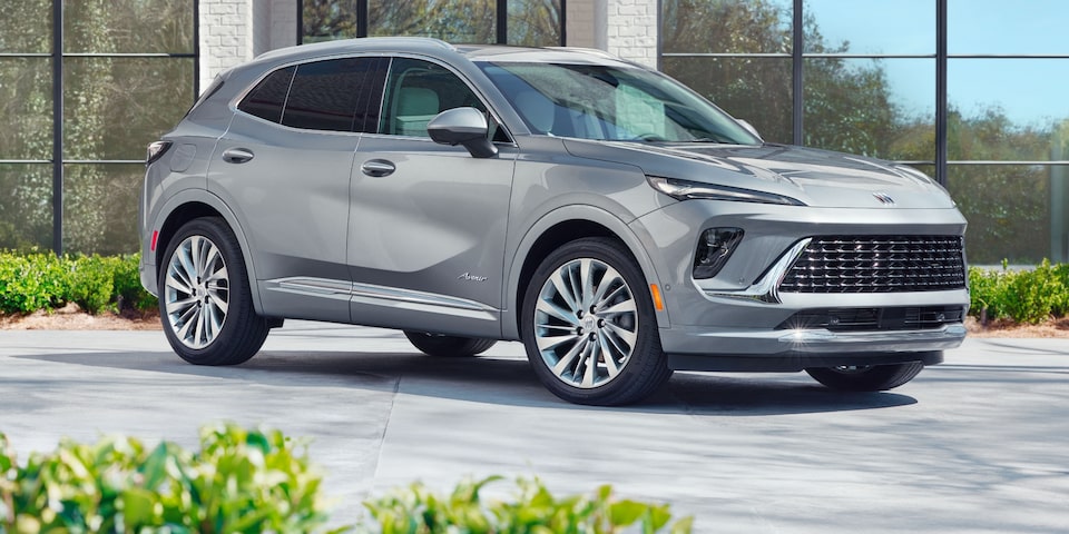 The 2024 Buick Envision parked near a building.