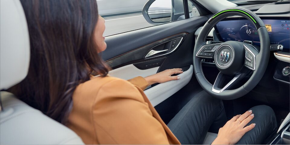 A person utilizing the hands-free driving feature of the 2024 Buick Envision.