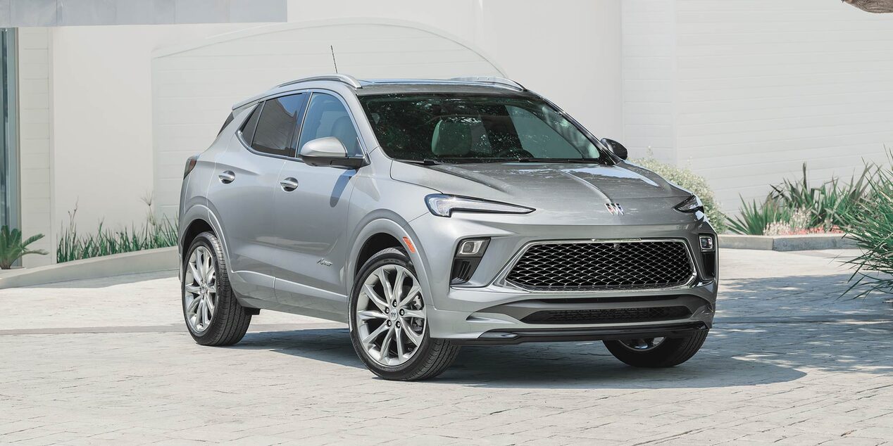 A Gray Buick SUV Parked in front of a Modern White Building with Green Landscaping