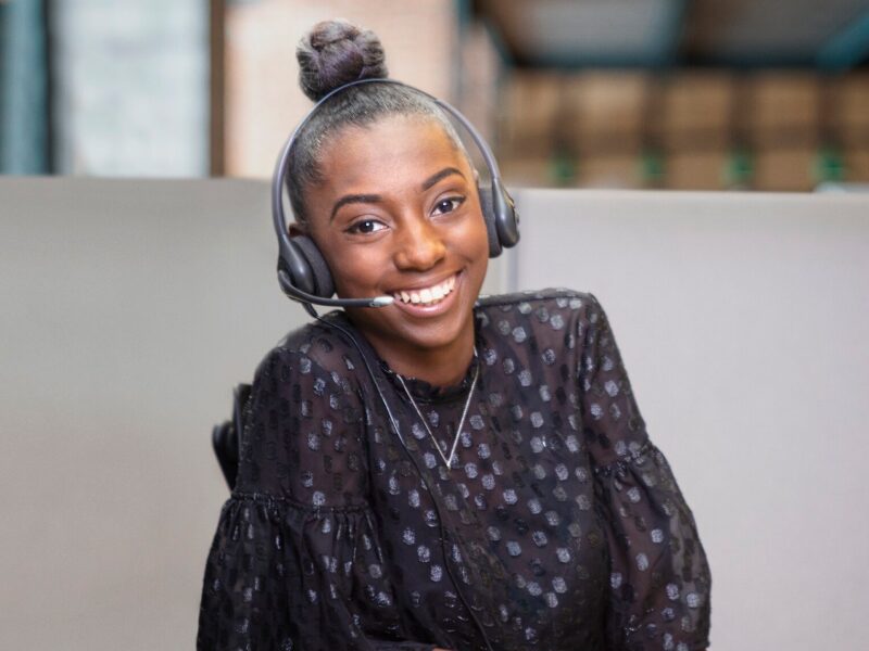 An OnStar Advisor Smiling with a Headset on
